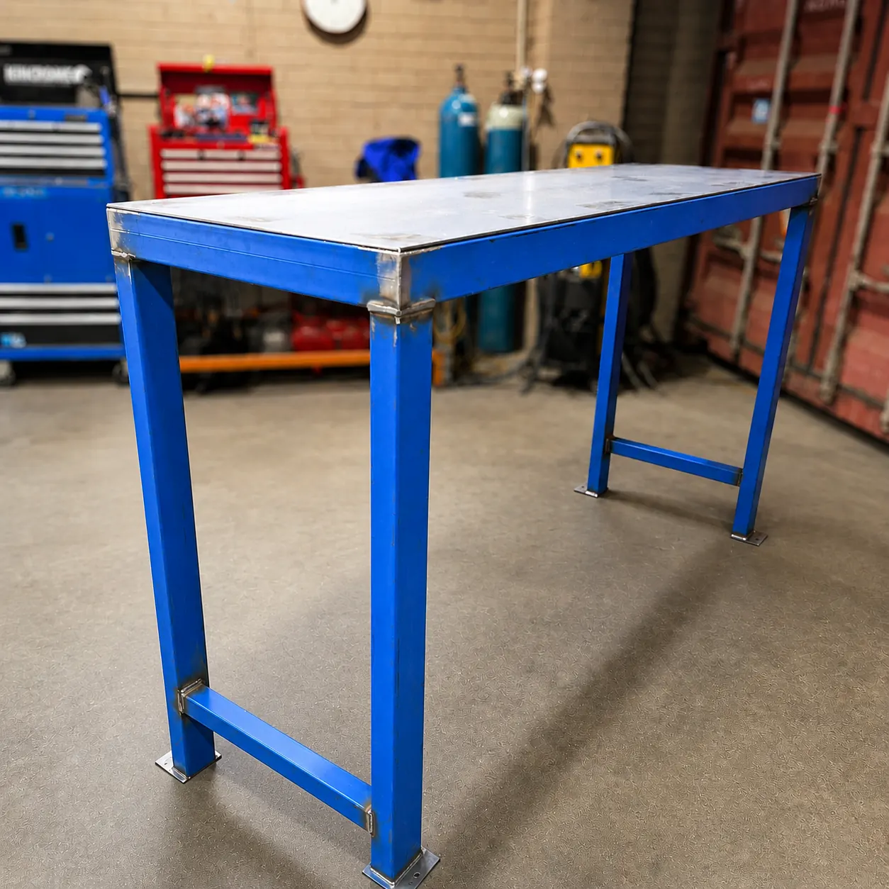 Raw steel custom workbench with lower shelf